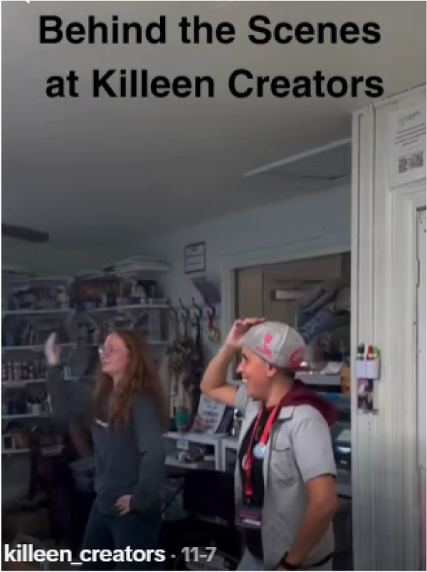 Two people happily dance in a cluttered creative workshop, filled with shelves and art supplies. The mood is lively and informal. Text above reads: 'Behind the Scenes at Killeen Creators.'