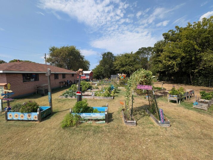 Hand-painted raised beds and climbing trellises holding the fall harvest ready to pick at Killeen Creators.